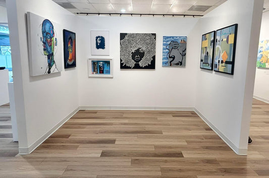 Ardest Art gallery with various artworks on white walls and wooden flooring. Observer boy Doug LaRue 2024