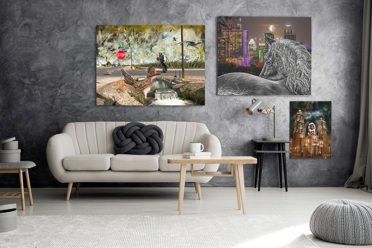 Three vertical canvas wall art prints displayed on a textured dark gray wall above a modern white sofa in a styled living room.