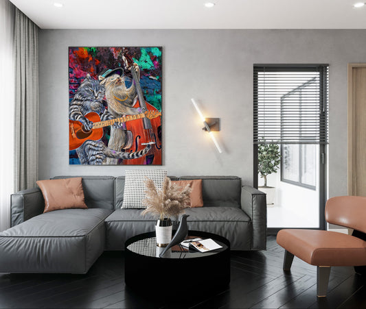 A modern living room with a gray sectional sofa, a black round coffee table, and a brown accent chair, featuring a colorful abstract painting of a cat playing guitar on the wall. Buskers & Scruffy Guitars by Doug LaRue