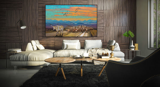 Sunset Longhorn Cattle Drive by Doug LaRueon a wood panel wall in a living room over a white couch