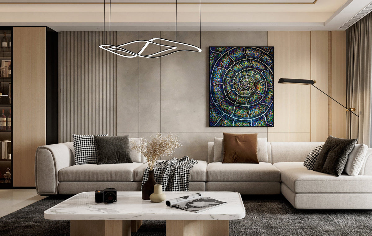 Modern living room with a sectional sofa, coffee table, and decorative wall art. Chromatic Nautilus Ammonite abstract painting by Doug LaRue