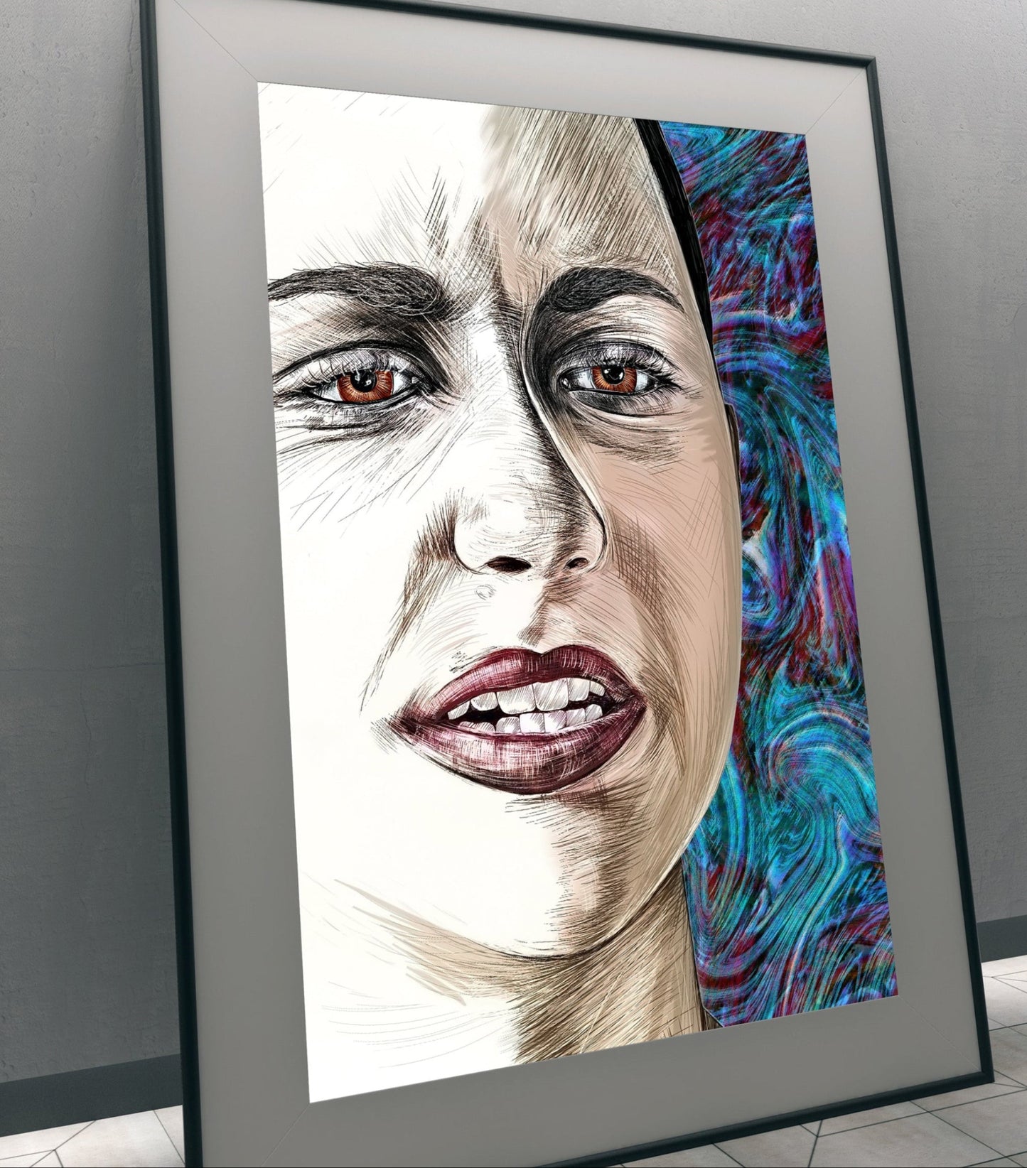 A framed portrait art print leaning against a gray wall in an indoor setting. The artwork shows a close-up of a woman's face with detailed shading and a vivid blue, purple, and teal patterned section on the right side.