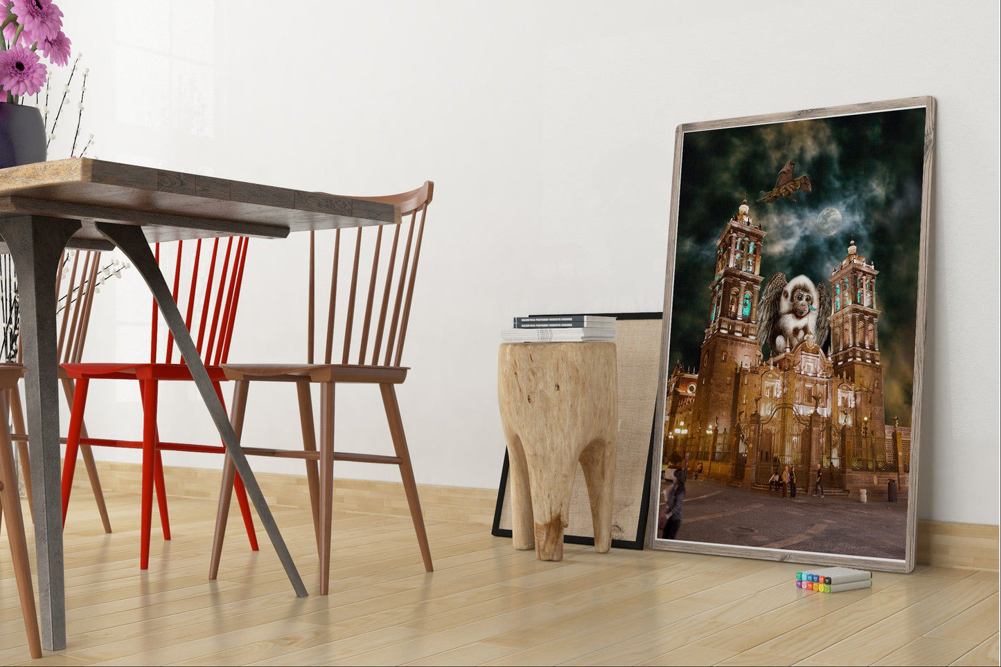 Dining area with wooden table, chairs, and a large framed picture on the wall. Flying Monkeys of Puebla bye Doug LaRue