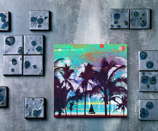 A square colorful art print depicting a tropical beach scene with palm trees, displayed on a textured gray wall alongside several matching square decorative tiles.
