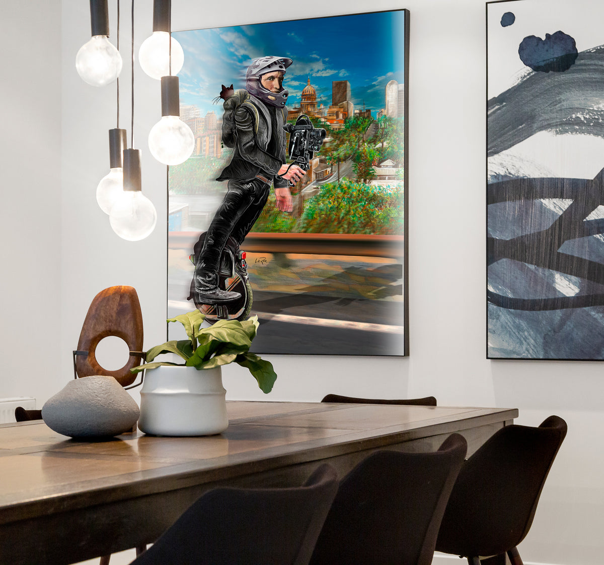 A framed vertical art print depicting a man wearing a helmet riding a unicycle in front of a city skyline, displayed on a white wall in a modern dining room setting. One Wheel Woody by Doug LaRue