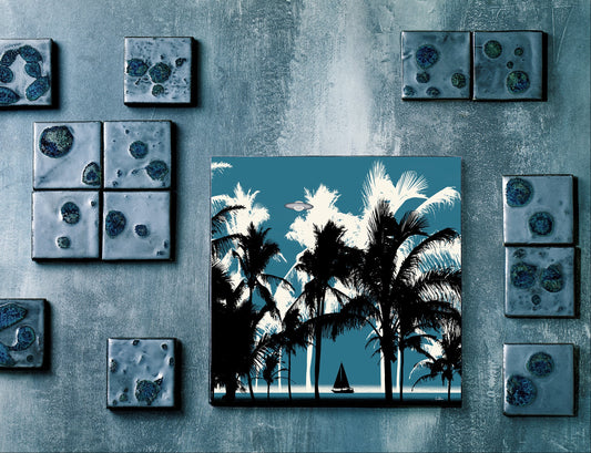 Majestic Beach by Doug LaRue on a gallery wall among smaller square artworks