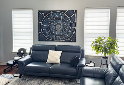 Ammonite abstract painting by Doug LaRue on a modern living room wall over a turquoise couch.