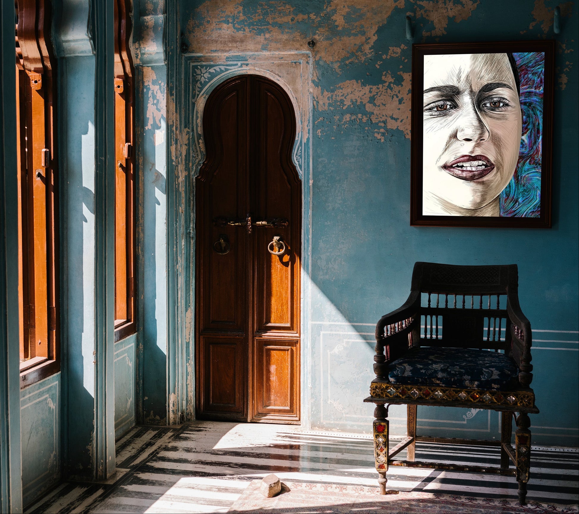 A framed portrait print of a woman's face hangs on a distressed blue wall in an old interior with wooden doors, windows, and a dark wooden chair. Emma Gonzales by Doug LaRue