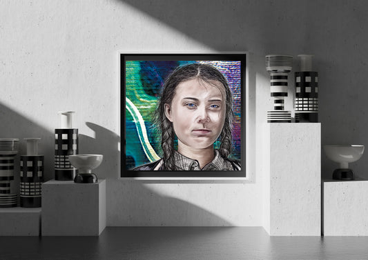 A framed portrait print of a young woman with braided hair, displayed on a textured gray wall in a styled interior setting with decorative vases and pedestal props.  Greta Thunberg by Doug LaRue