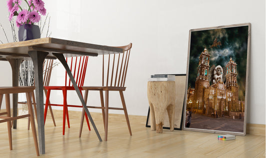 Dining area with wooden table, chairs, and a large framed picture on the wall. Flying Monkeys of Puebla bye Doug LaRue