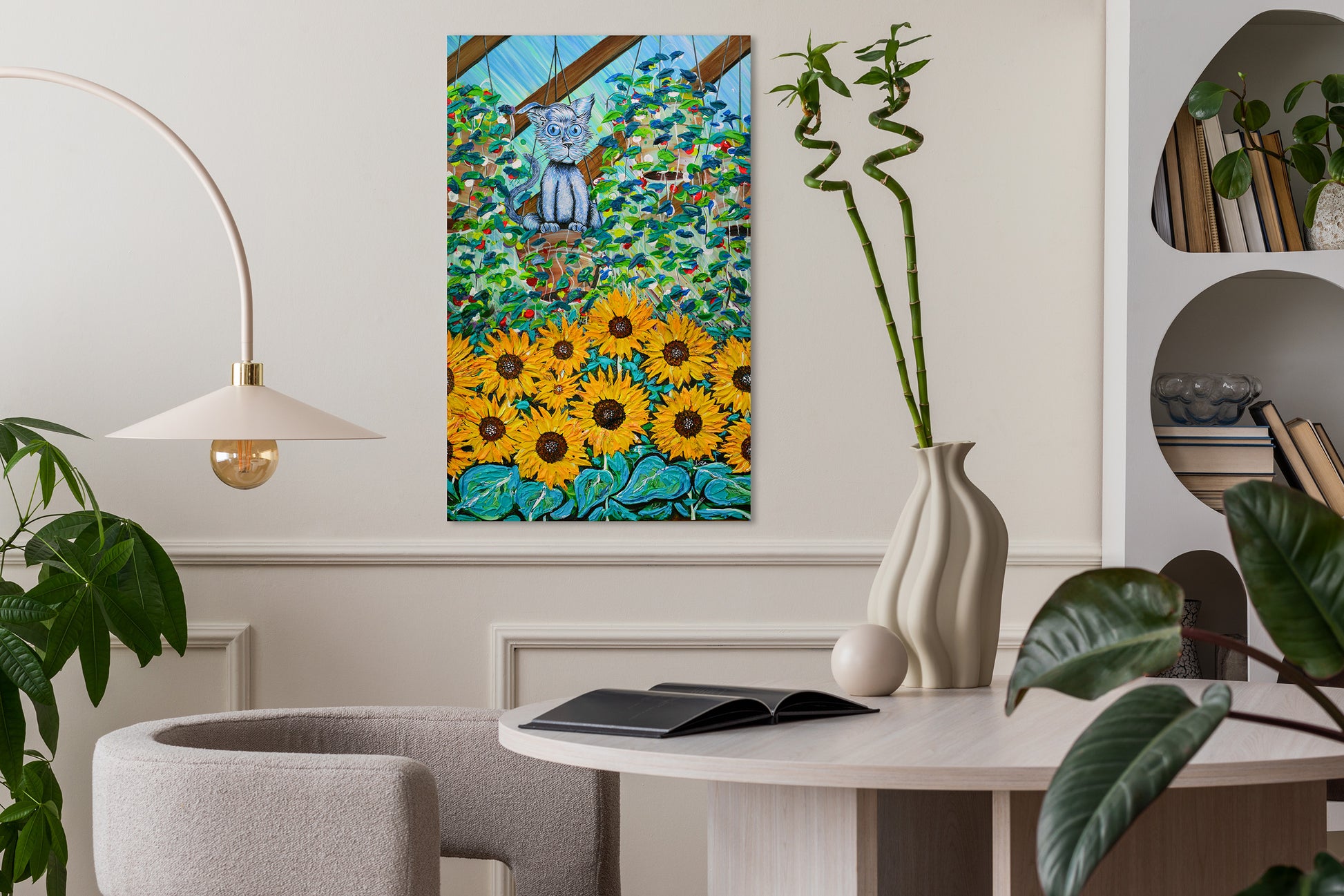 Decorative interior with a painting of sunflowers, a vase, and a book on a table. Green House by Doug LaRue