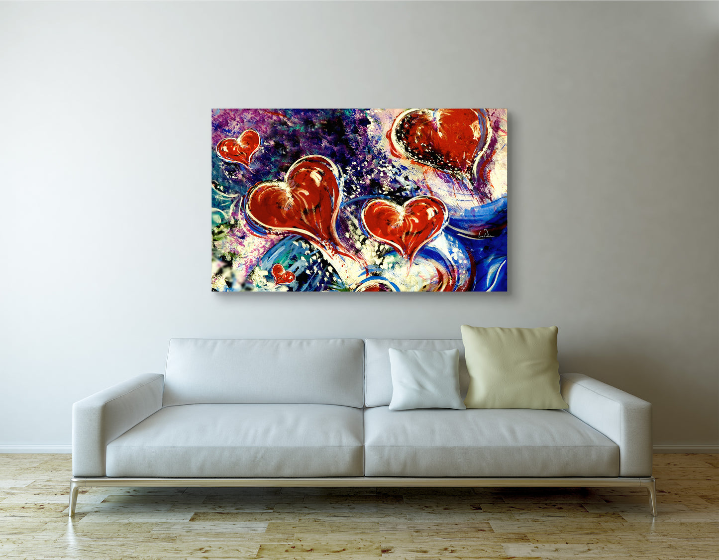 Colorful abstract painting with hearts above a white sofa in a living room. Hearts adrift art by Doug LaRue 