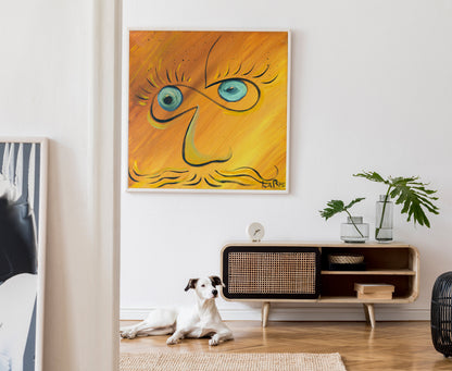 A framed abstract painting with a stylized face in yellow, orange, and blue hangs on a white wall above a wooden sideboard. A white dog lies on a woven rug on the floor below, and a potted plant sits on the cabinet.  Infinite Eyes #1 by Doug LaRue