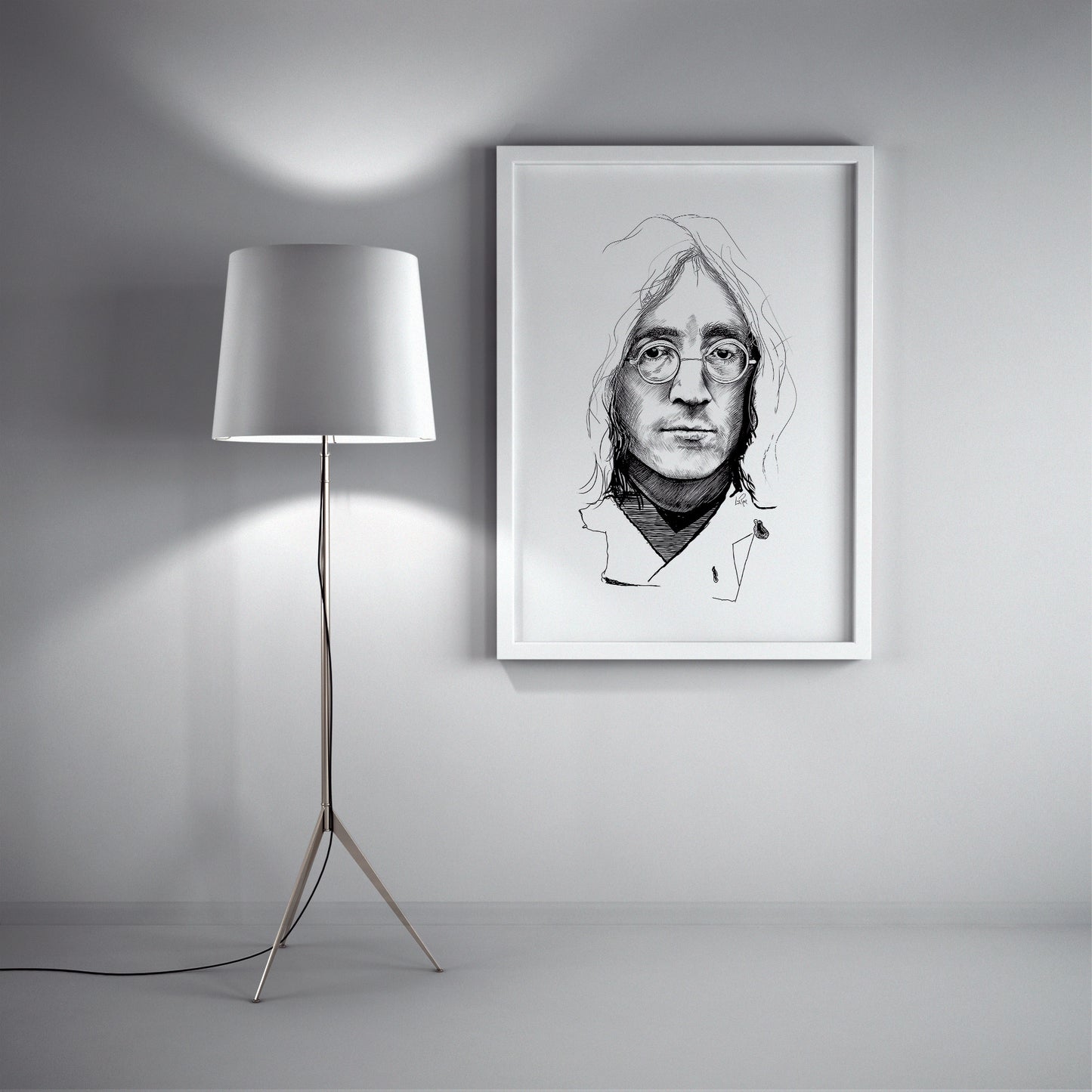 Framed black and white portrait of a person with glasses on a wall next to a floor lamp. John Lennon sketch by Doug LaRue