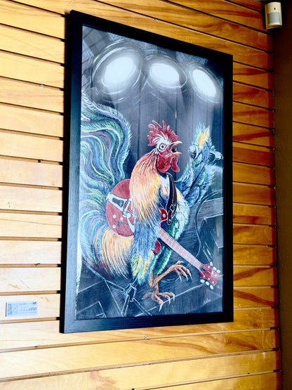 Framed artwork of ruling the Roost by Doug LaRue on a wooden wall at NeWorlDeli