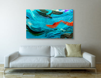 Sea Serpents abstract art by Doug LaRue, a colorful abstract painting on a wall above a white sofa with decorative pillows.