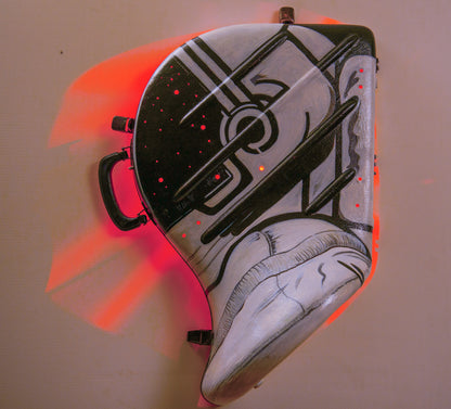 A hand-painted French horn case in the form of an astronauts helmet. Space Helmet with glowing LED party lights mounted inside to glow through hols in the helmet screen