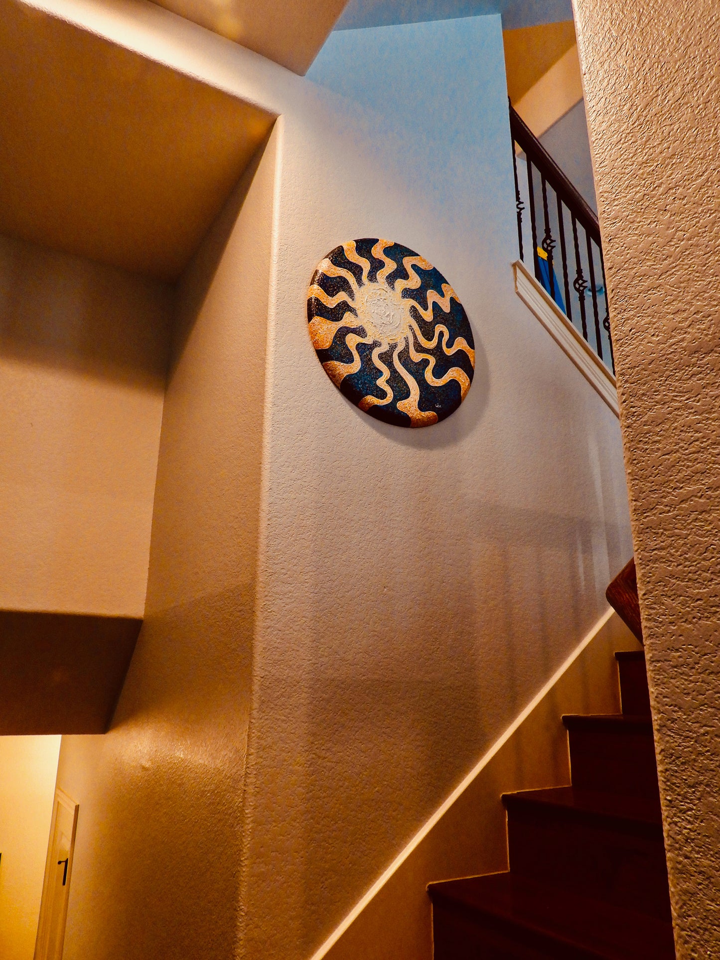 Sunburst by Doug LaRue on a wall in a stairway
