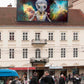 DJ Zedd the alien mix master mixed media by Doug LaRue on a large sign on a roof in Europe
