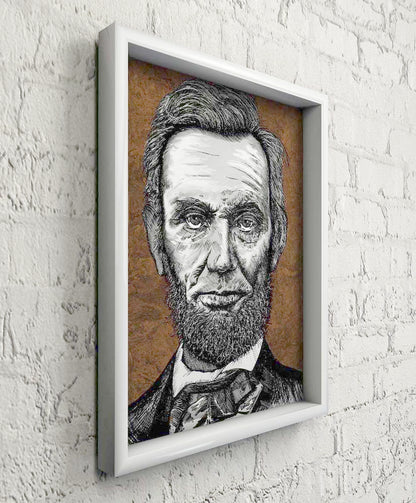 Ink portrait of President Abraham Lincoln on a white brick wall in a white woodl frame