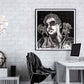 Doug LaRue Artist Portrait in a black metal frame on a white brick wall in an office